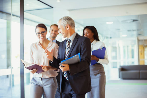 istock Business people walking and talking in office 521812165
