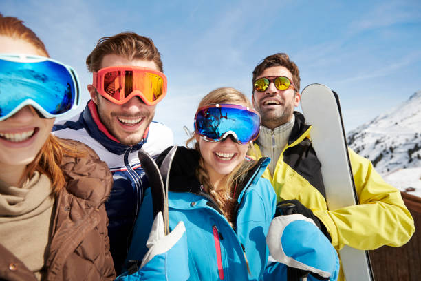 istock Friends carrying skis on mountain top 521812189