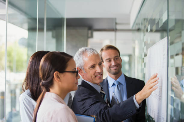 istock Business people discussing documents in office building 521812195