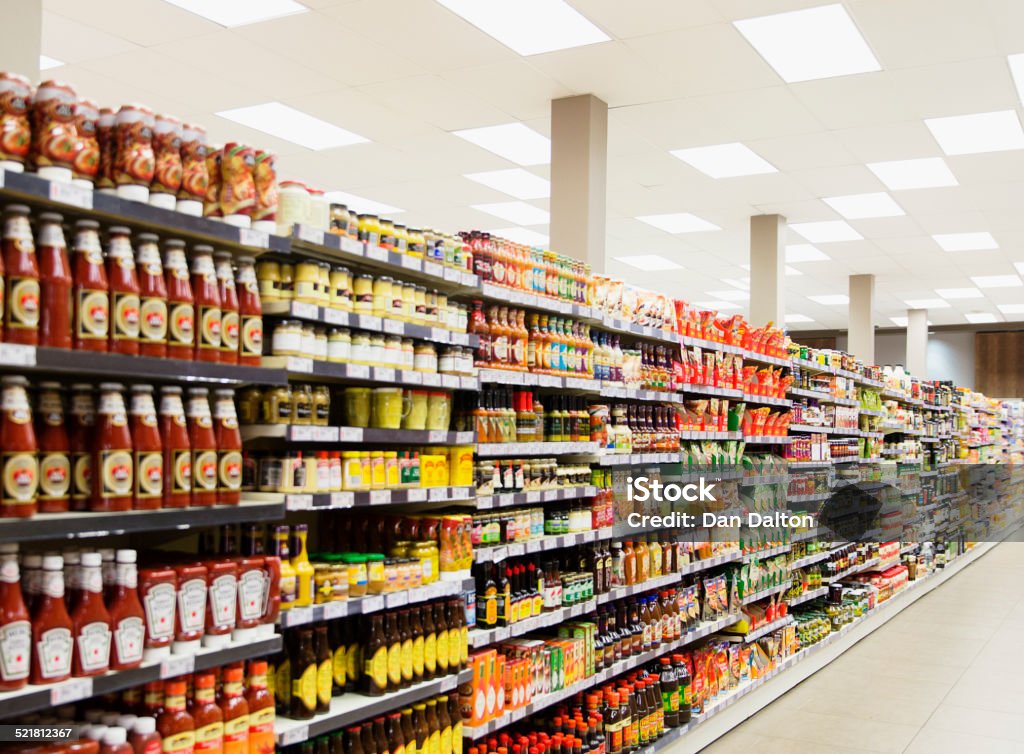 Stocked shelves in grocery store aisle  Supermarket Stock Photo