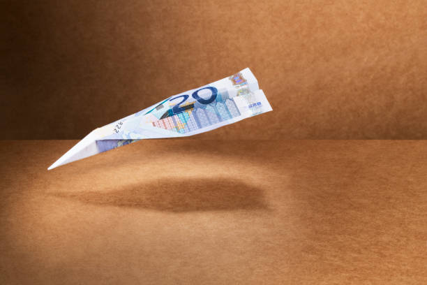 20 Euro note folded into paper airplane  devaluation stock pictures, royalty-free photos & images