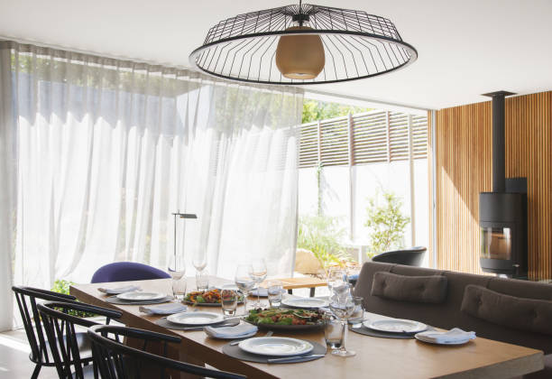 istock Chandelier over dining table in modern dining room 521812495