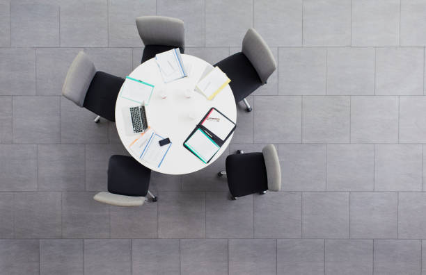 istock Paperwork scattered on meeting table in office building 521812849