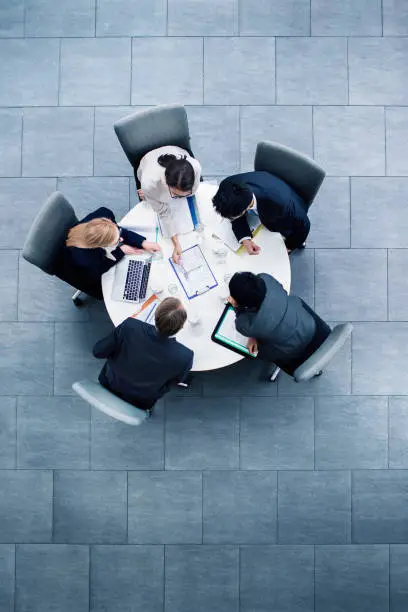 Photo of Business people having meeting at table