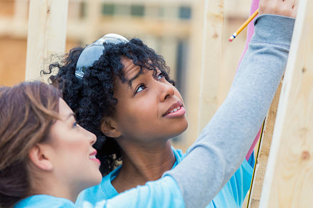 istock Diverse volunteers build charity home 521812980