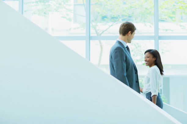 istock Business people crossing paths on staircase 521813009