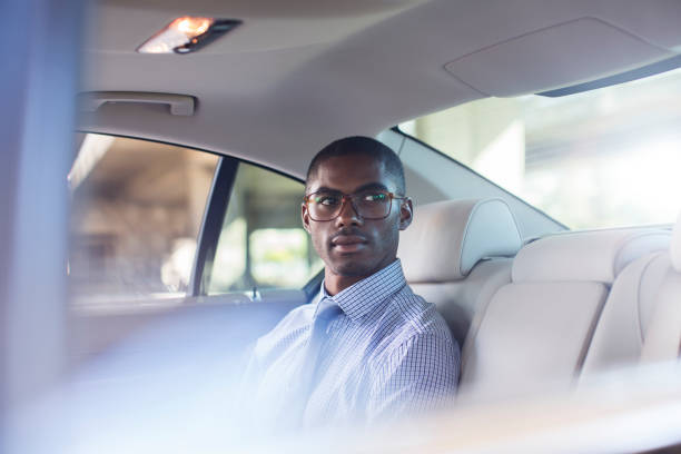 istock Businessman sitting in car back seat 521813097