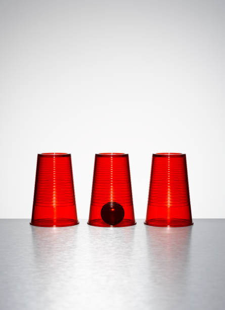 istock Ball under middle of three clear red cups 521813217