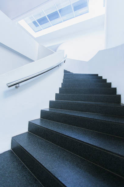 istock Black and white winding staircase of office building curving 521813267