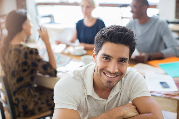 istock Businessman smiling at meeting in cafe 521813311