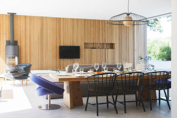 istock Dining table, sofas and television in open living room and dining room 521813357