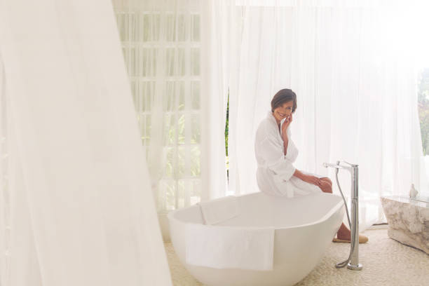 istock Woman running bath in modern bathroom 521813419