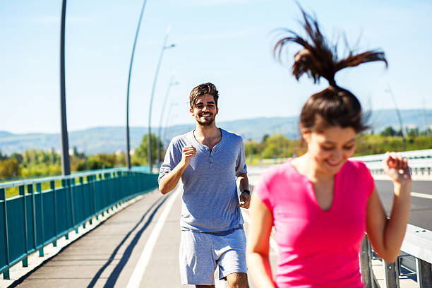 istock Young sport couple running together 521814156