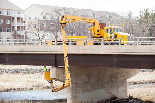 Rochester, Minnesota, USA - April 11, 2016: Zumbro River bridge inspection by Minnesota Department of Transportation. 