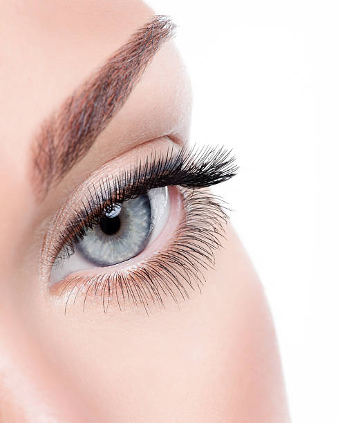 istock Beauty female eye with curl long false eyelashes 521816204