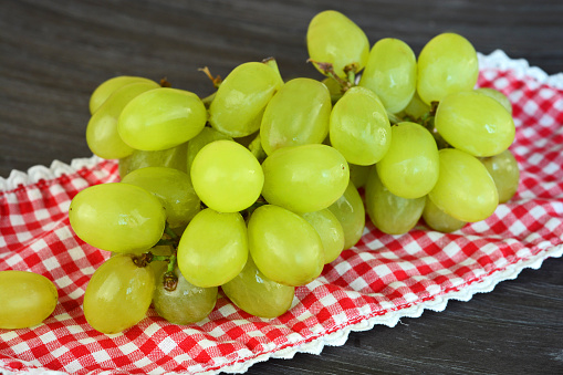 natural green grapes on a wooden background in country style