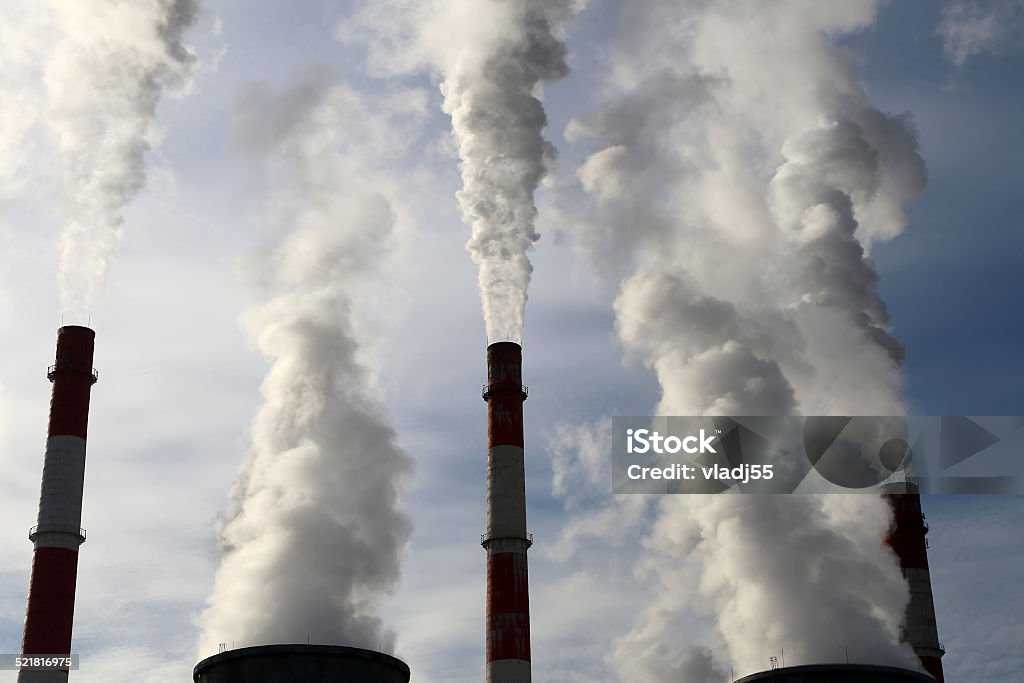 Smoke stacks at coal burning power plant Burning Stock Photo