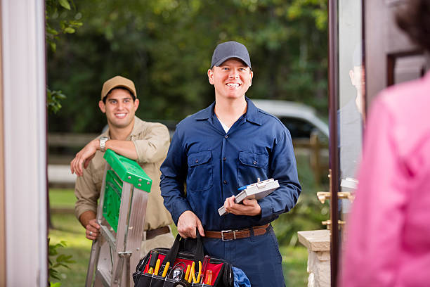 istock Service Industry: Two multi-ethnic repairmen at customer's front door. 521817467