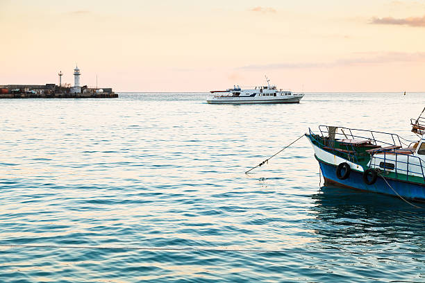 istock lighthouse and Black Sea in yellow evening, Yalta 521817557
