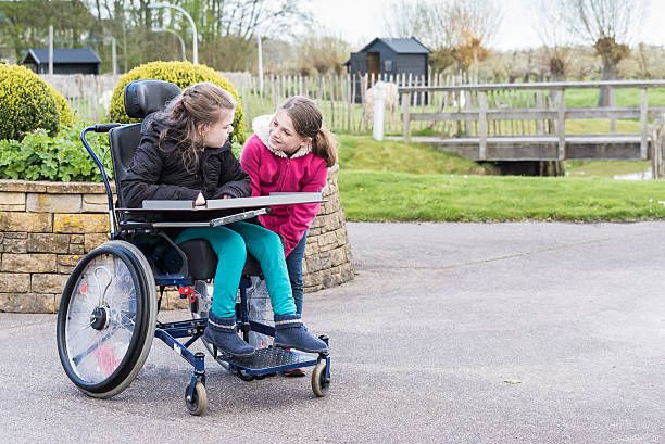 istock Disability a disabled person   together with her sister 521817598