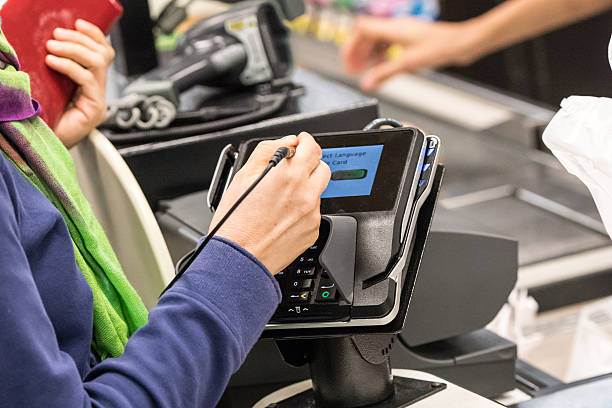 Caucasian woman electronic signing her bill