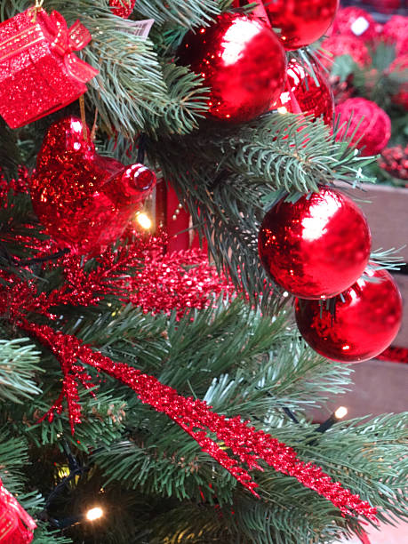 istock Artificial Christmas tree, red decorations, garlands, baubles, tinsel, parcels, fairy-lights 521817957