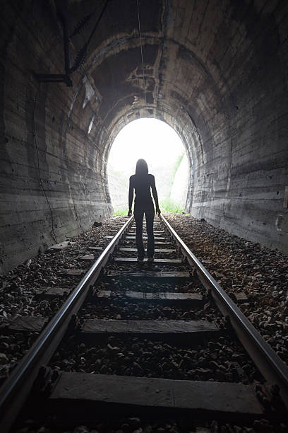 istock Man in a tunnel looking towards the light 521818052