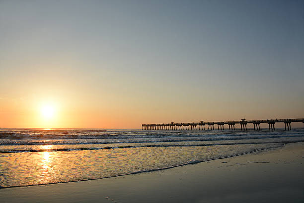istock Beautiful sunrise over the ocean and pier. 521818326