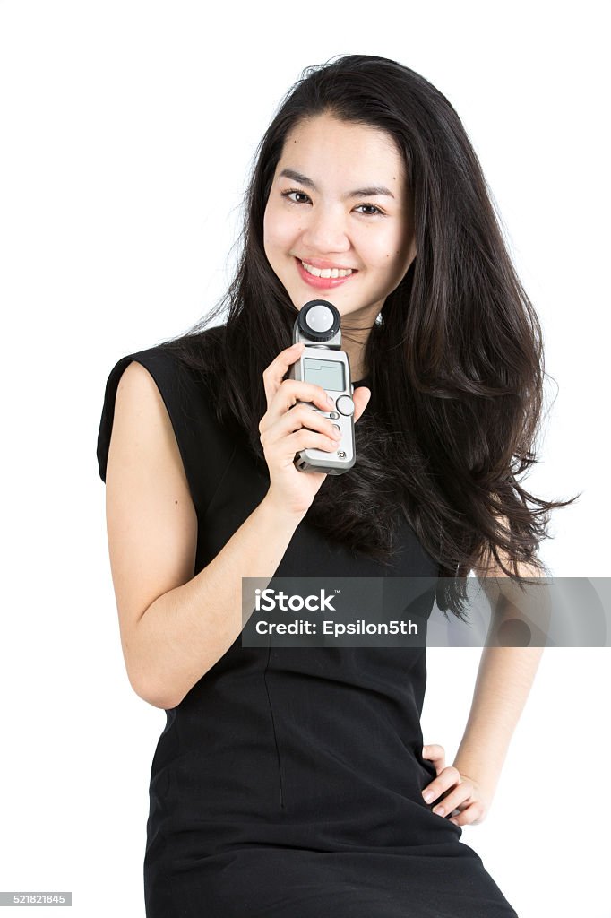 Young asain model using a light meter Adult Stock Photo