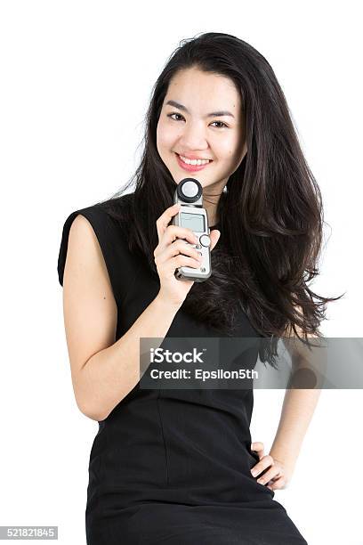 Young Asain Model Using A Light Meter Stock Photo - Download Image Now - Adult, Aperture, Asian and Indian Ethnicities