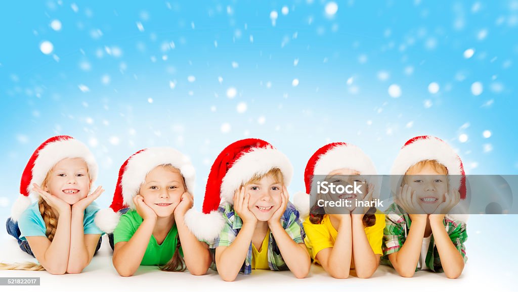 Christmas Children, Santa Helper Hat, Xmas Kids Boys and Girls Christmas Children In Santa Helper Hat, Little Kids Boys and Girls Happy Greeting Xmas Holiday Assistance Stock Photo