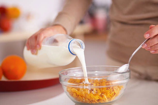 istock Smiling attractive woman having breakfast in kitchen interior 521822975