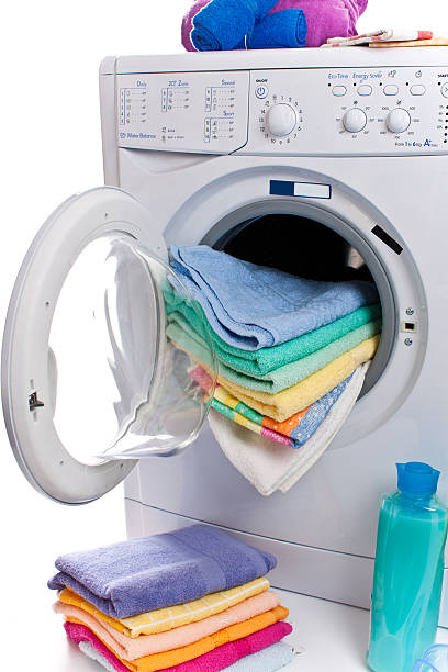 istock washing machine isolated on white, cleaning agents and cloths. 521828017