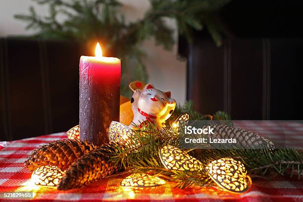 New Year Home Decoration With Maneki Neko And Candle Stock Photo - Download Image Now