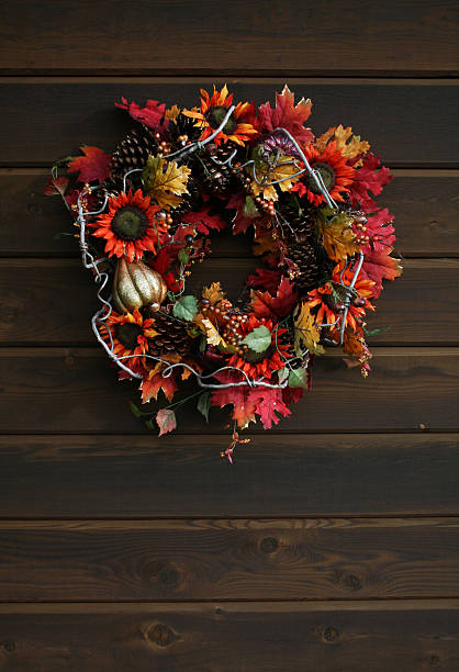 istock Fall wreath hung against wood paneling 521830941