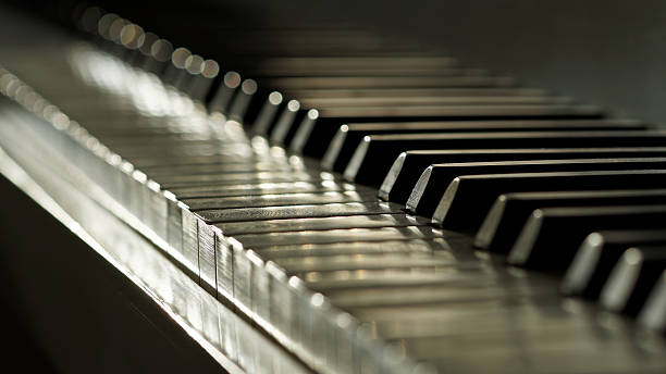 Real Ivory keyed piano in low depth of field stock photo