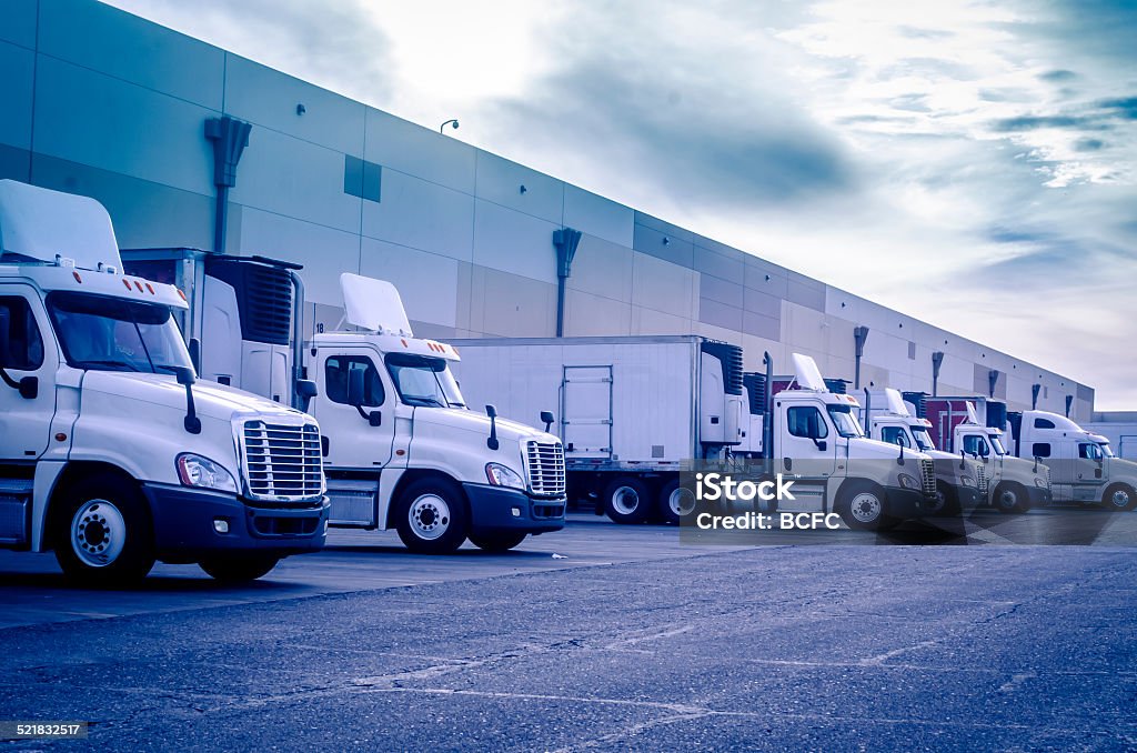 Trucks loading unloading at warehouse Trucks loading unloading at warehouse logistics transportation concept image Truck Stock Photo