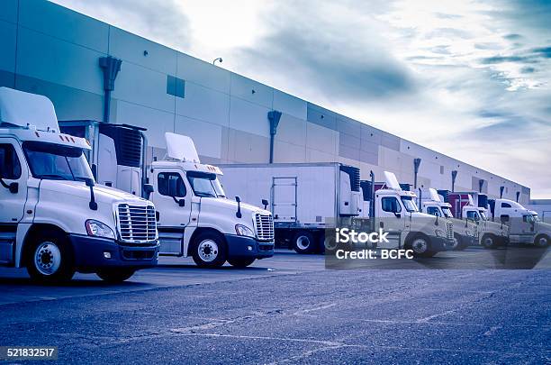 Trucks Loading Unloading At Warehouse Stock Photo - Download Image Now - Truck, Trucking, Fleet of Vehicles