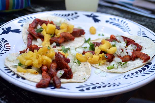 istock Three tacos al pastor on corn tortillas 521832863