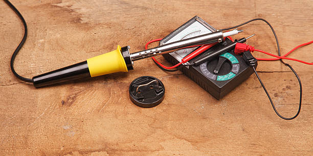 istock Soldering iron on a wooden table 521833941