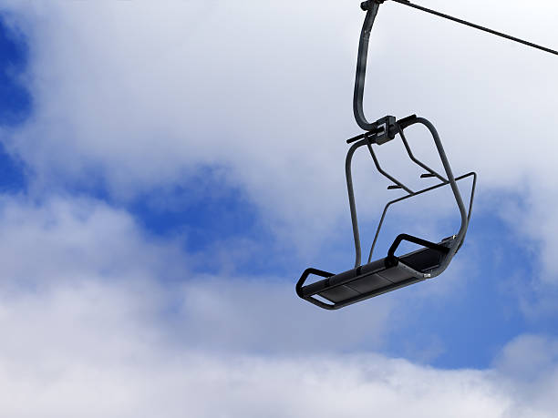 istock Chair-lift and blue sky with clouds 521834049