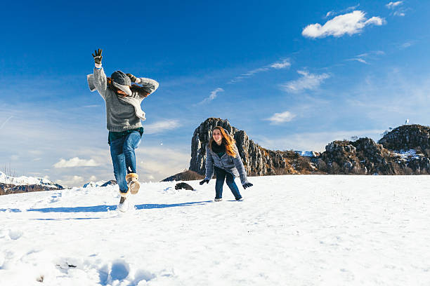 istock Young women playing in snow 521849257