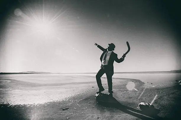 Photo of Businessman Tossing a Boomerang to the Sun