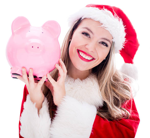Female Santa holding a piggybank - Christmas sale concepts