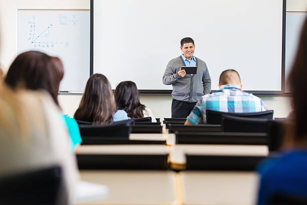 istock Hispanic professor teaching class of high school or college students 521850383