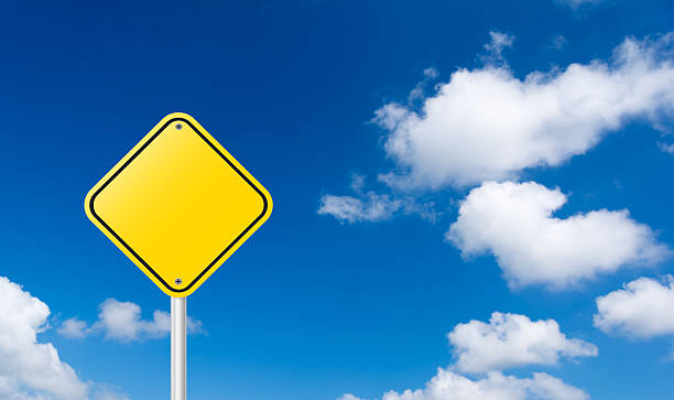 istock blank yellow traffic sign with blue sky background 521850641