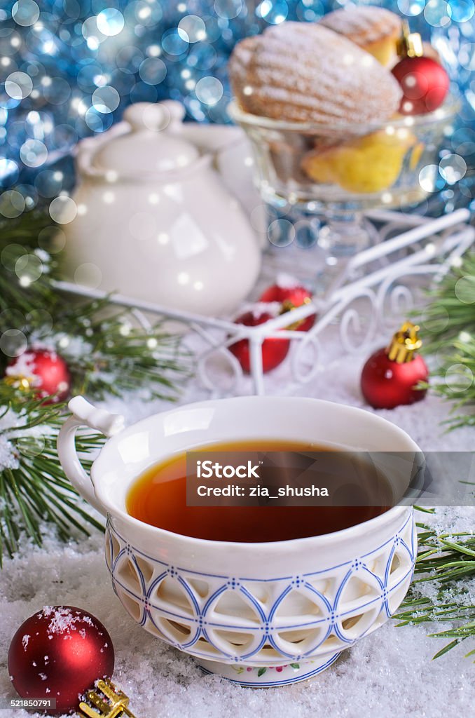 Christmas composition Cup of brown liquid on the snow on the background of Christmas decorations Appetizer Stock Photo