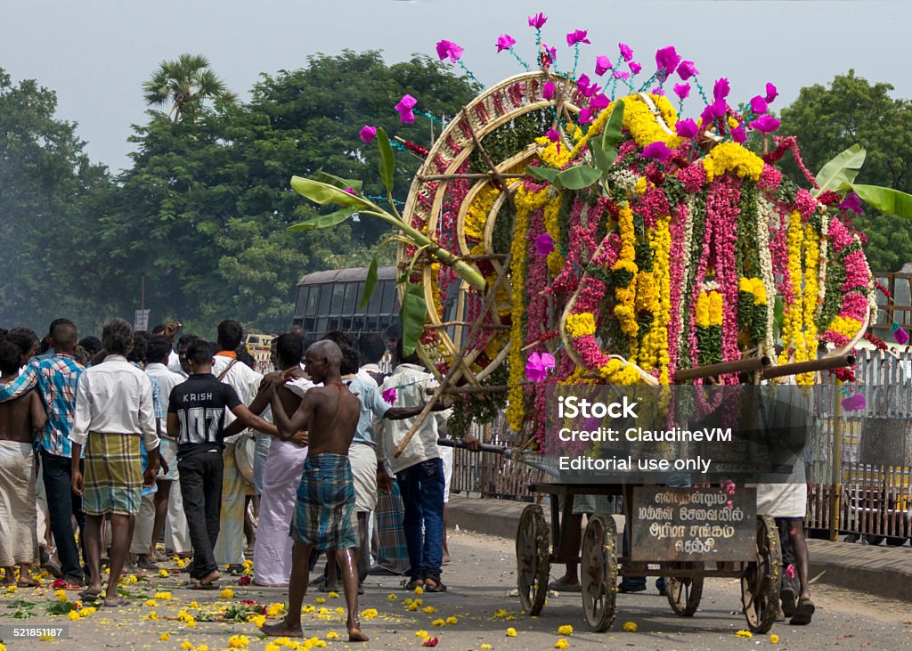 Funeral procession in Gingee, Tamil Nadu. Gingee, India - October 9, 2013: A funeral procession with only male participants proceeds through the streets of Gingee. The deceased man is exposed on a pushcart covered with flowers. Adult Stock Photo