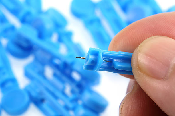 istock lancet for blood sugar and finger 521851231