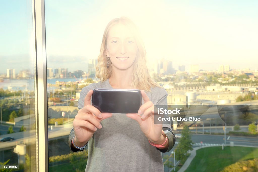 Young Woman Taking A Selfie, Boston Young Woman Taking A Selfie in front of window. Boston, USA Adult Stock Photo